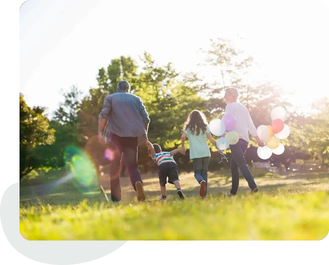 A group of people walking in the grass.