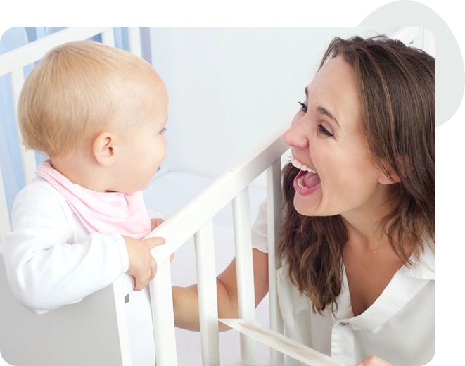 A woman holding onto the back of her baby