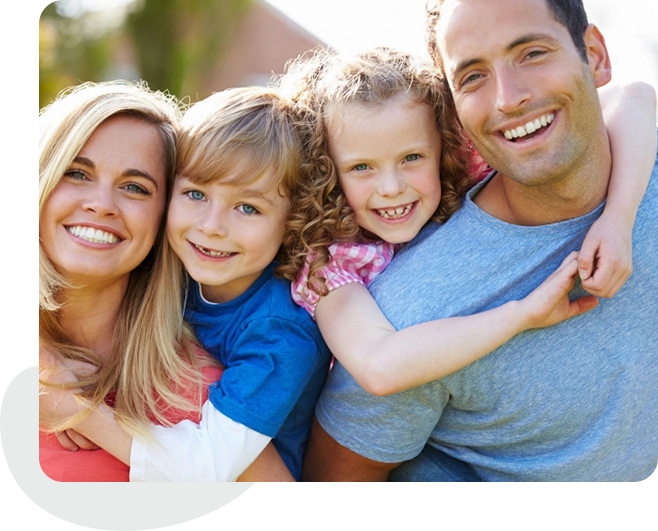 A family of four smiling for the camera.