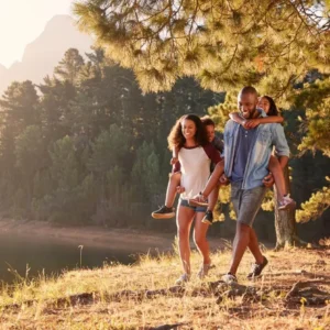 a couple carrying their kids on thier back