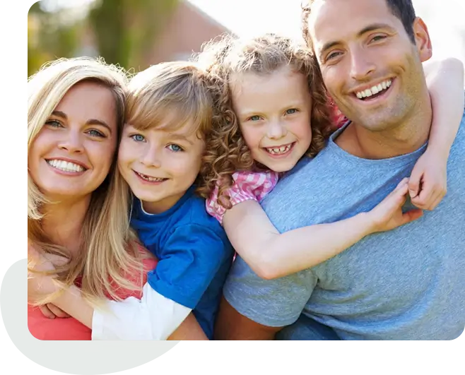 A family of four smiling for the camera.